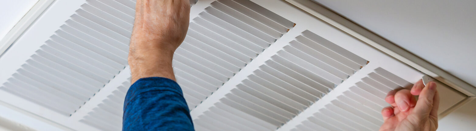 Man with blue shirt releases HVAC locks to begin maintenance