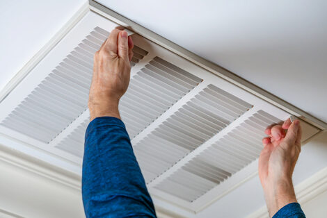 Man with blue shirt releases HVAC locks to begin maintenance