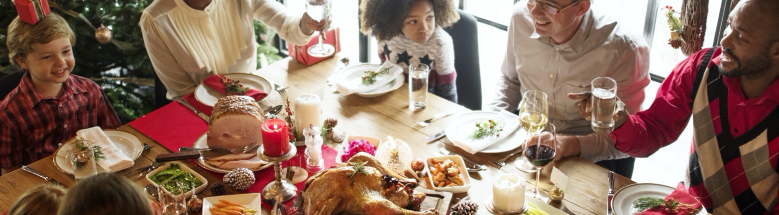 multicultural family and friends enjoying a holiday meal