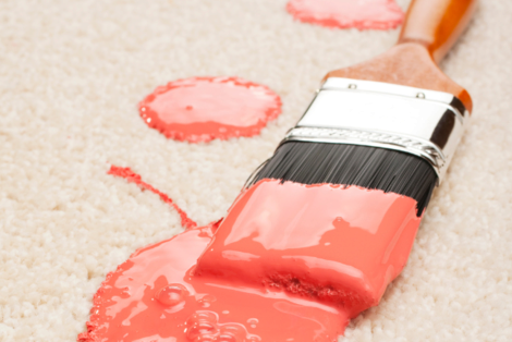 Paint brush with paint spill on carpet